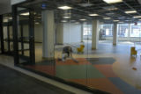 Worker cleaning the floors of the interior of Kirby Student Center during renovation