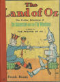 The land of Oz : being an account of the further adventures of the Scarecrow and Tin Woodman, and also the strange experiences of the Highly Magnified Woggle-Bug, Jack Pumpkinhead, the Animated Saw-Horse and the Gump