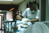 A nurse stands by a patient at Mount Sinai Hospital, Minneapolis, Minnesota