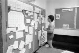 Student looking at Outdoor Recreation bulletin boards in Kirby Student Center