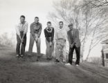 UMD 1963 men's golf team posed with clubs on golf course