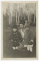 David and John Hartley standing together with Carolyn Warmington Munger kneeling beside them in the front yard of the house of Cavour Hartley at 3800 East Superior Street