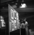Two people looking at artwork in Kirby Student Center