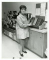 A medical library volunteer at the Mount Sinai Hospital places a book on a shelf, Minneapolis, Minnesota