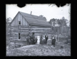 Mr. Cummings's log home with group standing in front of it