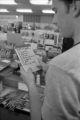 Student reading at a shopping list in the Bulldog Shop at UMD