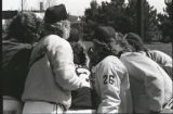 UMD 1987 women's softball team huddled during game