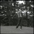 Action shot of UMD 1983 golfer swinging golf club