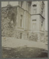 Child standing by the Hartley house at 1305 East Superior Street with another on the front porch