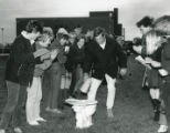 Group of students playing "Flush the Johnny" during 1967 Homecoming activities