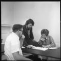 Three people at a table in the School of Social Work at UMD