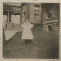 Judith Hartley standing in front of the Hartley house at 1305 East Superior Street