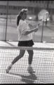 Action shot of UMD 1992 women's tennis player hitting ball on the tennis court
