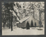 Carrie Eliza, Judith, and Guilford Graham Hartley standing outside a tent in the snow