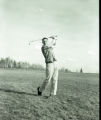Action shot of UMD 1957 golfer hitting ball