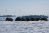 Round hay bales and wind turbines in winter on Buffalo Ridge, Pipestone County, Minnesota.