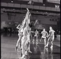 Action shot of UMD 1999 women's basketball players playing on the court