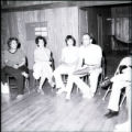 A man holding an object speaks to others at Camp Tikvah, Aitkin, Minnesota