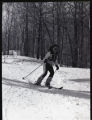 Action shot of UMD 1979 women's downhill skier on the slopes