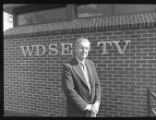 A person standing in front of the WDSE-TV building on UMD campus