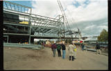 People gathered around part of the steel framing at the Swenson Science Building construction site