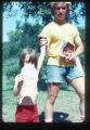Camp Butwin staff member stands by a camper who holds a paper that reads, "Best Calves", Eagan, Minnesota