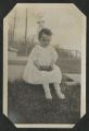 Child sitting on the front steps of a house