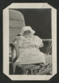 Chester Adgate Congdon II as a baby sitting in a wicker chair outside of Congdon Castle
