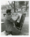 One of the senior citizen volunteers at the "Lark in the Park" event at Loring Park trying a hand at charcoal sketching, Minneapolis, Minnesota