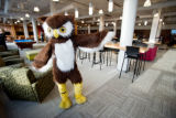 Owl mascot posing in Kirby Student Center lounge