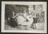 Carrie Eliza Hartley sitting beside Chester Adgate II, Clara, G.G.H., and John Congdon on a patio at Congdon Castle
