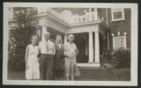 Mary Hartley, Roland Hill Hartley, and Nina Clough standing with another unidetified person in front of the Governor's Mansion in Tacoma