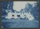 Judith Hartley sitting with three other children sitting in the grass together outside of the Hartley house at 1305 East Superior Street