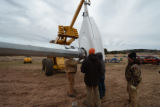A crane assembling the windmill at UMD Farm