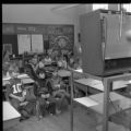Children sitting in a classroom watching television in the WDSE-TV building on the UMD campus