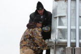 Workers attaching bolts to the windmill at UMD Farm