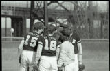 UMD 1985 women's softball team huddled during a game