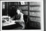 Bessy Juster seated in a law office
