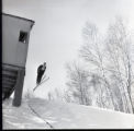 Action shot of UMD 1965 skier doing a jump during a tournament