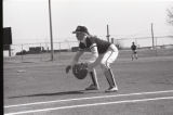 Action shot of UMD 1986 women's softball player getting ready to catch ball