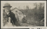 Carrie Eliza Hartley sitting with an unidentified child by a boat landing on Wolf Lake