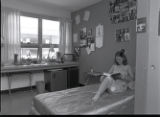 Student reading in their Lake Superior Hall dorm