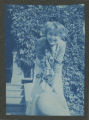 Child sitting on the balustrade on the steps to the Hartley house at 1305 East Superior Street