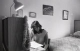 Student doing homework in bedroom in the Stadium Apartments