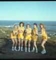 UMD 1990 women's basketball players #52, #44, and others posed together outside