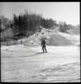 Action shot of UMD 1956 downhill skier