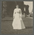 Carrie Eliza Hartley in a white dress in front of the Hartley House at 1305 East Superior Street