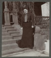 Carrie Eliza Hartley standing on the front steps of the Hartley house at 1305 East Superior Street