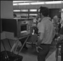 A student at a microwave in Ven Den lounge at UMD