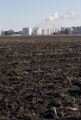 Ethanol plant at Lamberton, Minnesota with corn residue plowed under in field.